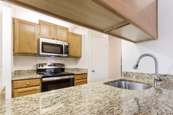 This is a photo of the kitchen in the 1245 square foot 2 bedroom, 2 bath apartment at Cambridge Court Apartments in Dallas, TX.