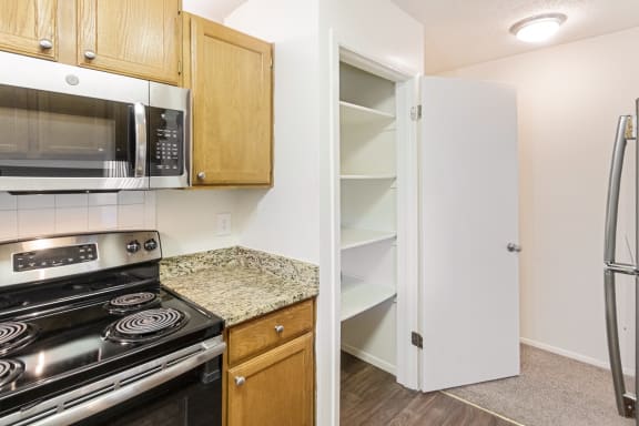This is a photo of the pantry in the kitchen in the 1245 square foot 2 bedroom, 2 bath apartment at Cambridge Court Apartments in Dallas, TX.