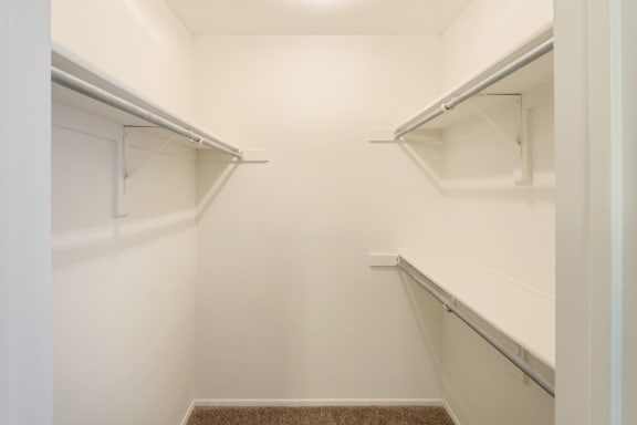 This is a photo of the walk-in closet in the second bedroom in the 1245 square foot 2 bedroom, 2 bath apartment at Cambridge Court Apartments in Dallas, TX.