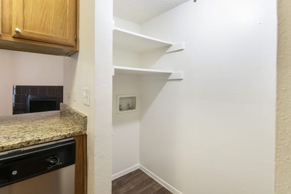 This is a photo of the washer and dryer connections in the 1245 square foot 2 bedroom, 2 bath apartment at Cambridge Court Apartments in Dallas, TX.