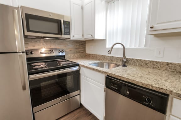 This is a photo of the kitchen in the 450 square foot efficiency apartment at Cambridge Court Apartments in Dallas, TX.