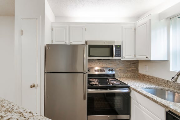 This is a photo of the kitchen in the 450 square foot efficiency apartment at Cambridge Court Apartments in Dallas, TX.