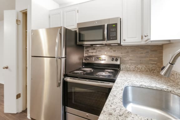 This is a photo of the kitchen in the 450 square foot efficiency apartment at Cambridge Court Apartments in Dallas, TX.