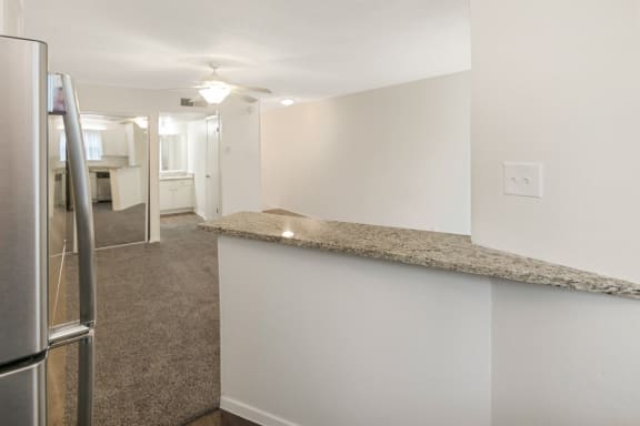 This is a photo of the living area from the kitchen in the 450 square foot efficiency apartment at Cambridge Court Apartments in Dallas, TX.