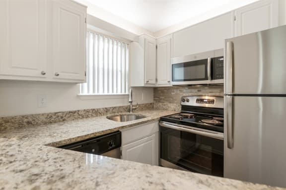 This is a photo of the kitchen in the 450 square foot efficiency apartment at Cambridge Court Apartments in Dallas, TX.