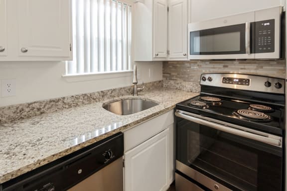 This is a photo of the kitchen in the 450 square foot efficiency apartment at Cambridge Court Apartments in Dallas, TX.