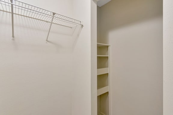 This is a photo of the built-in shelves at the end of the huge walk-in closet in the 530 square foot efficiency apartment at Cambridge Court Apartments in Dallas, TX.
