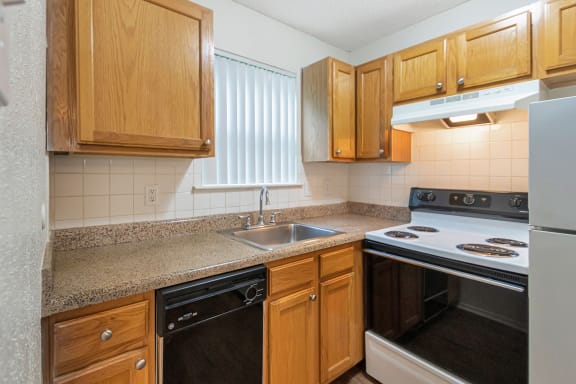 This is a photo of the kitchen in the 530 square foot efficiency apartment at Cambridge Court Apartments in Dallas, TX.