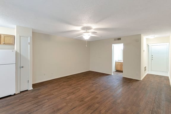 This is a photo of the living area in the 530 square foot efficiency apartment at Cambridge Court Apartments in Dallas, TX.