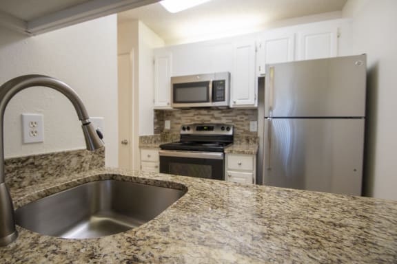 This is a photo of the kitchen of a 612 square foot 1 bedroom apartment at Cambridge Court Apartments in Dallas, TX.