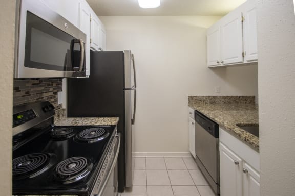This is a photo of the kitchen of a 612 square foot 1 bedroom apartment at Cambridge Court Apartments in Dallas, TX.