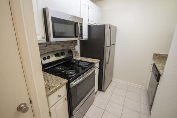 This is a photo of the kitchen of a 612 square foot 1 bedroom apartment at Cambridge Court Apartments in Dallas, TX.