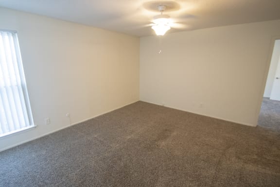 This is a photo of the living room of a 612 square foot 1 bedroom apartment at Cambridge Court Apartments in Dallas, TX.