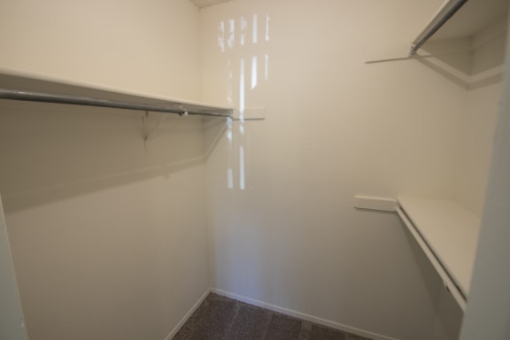 This is a photo of the second bedhroom walk-in closet of a 1086 square foot 2 bedroom  apartment at Cambridge Court Apartments in Dallas, TX.