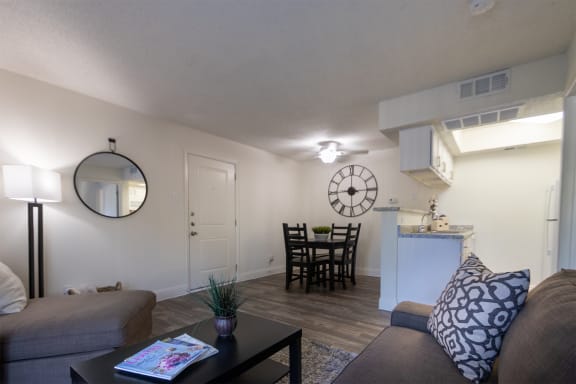 This is a photo of the living room and dining area of the 515 square foot 1 bedroom apartment at Canyon Creek Apartments in Dallas, TX