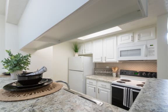 This is a photo of the kitchen of the 575 square foot 1 bedroom, 1 bath apartment at Canyon Creek Apartments in Dallas, TX