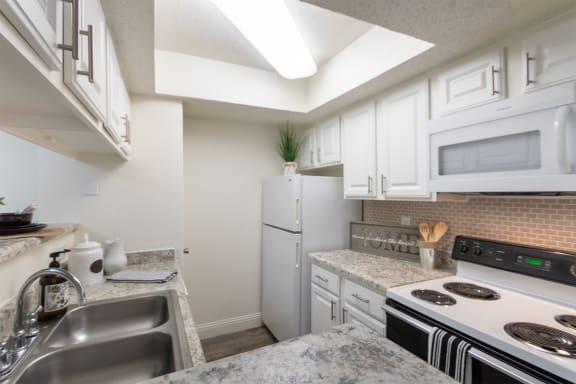 This is a photo of the kitchen of the 575 square foot 1 bedroom, 1 bath apartment at Canyon Creek Apartments in Dallas, TX