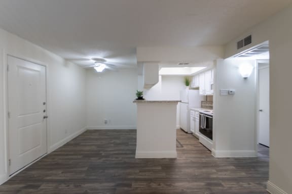 This is a photo of the dining area and kitchen of the 575 square foot 1 bedroom, 1 bath apartment at Canyon Creek Apartments in Dallas, TX