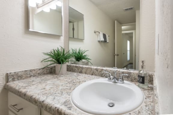This is a photo of the bathroom vanity of the 575 square foot 1 bedroom, 1 bath apartment at Canyon Creek Apartments in Dallas, TX