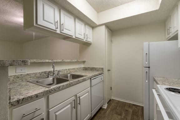 This is a photo of the kitchen in the 880 square foot 2 bedroom, 2 bath apartment at Canyon Creek Apartments in Dallas, TX