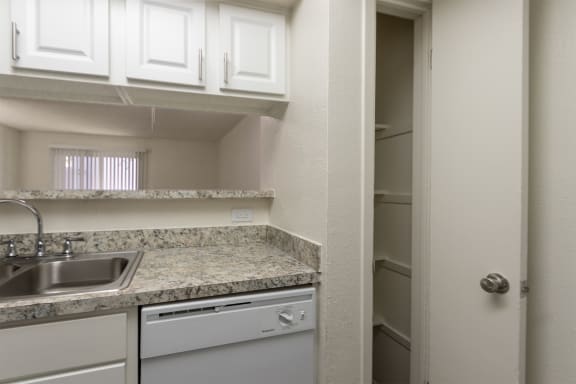 This is a photo of the kitchen featuring the pantry in the 880 square foot 2 bedroom, 2 bath apartment at Canyon Creek Apartments in Dallas, TX