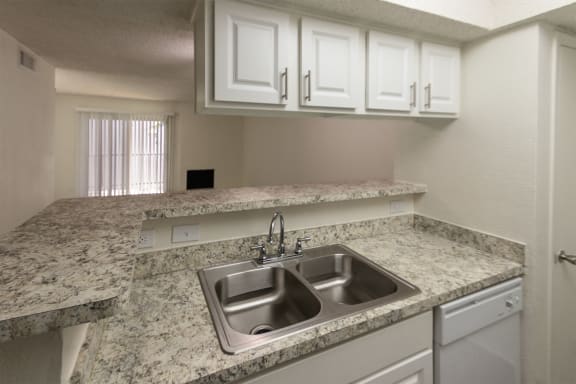 This is a photo of the kitchen in the 880 square foot 2 bedroom, 2 bath apartment at Canyon Creek Apartments in Dallas, TX