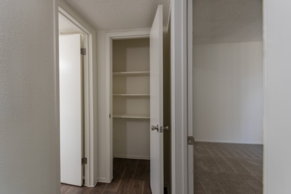 This is a photo of the hallway closet in the 880 square foot 2 bedroom, 2 bath apartment at Canyon Creek Apartments in Dallas, TX