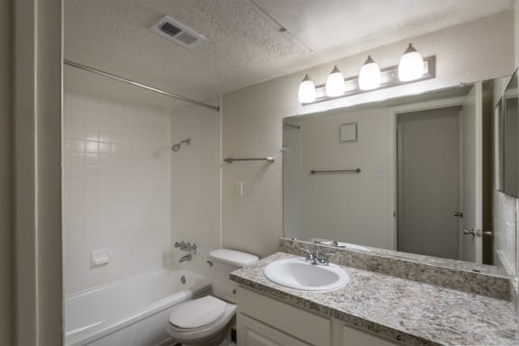 This is a photo of the bathroom in the 880 square foot 2 bedroom, 2 bath apartment at Canyon Creek Apartments in Dallas, TX