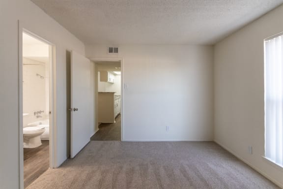 This is a photo of the primary bedroom in the 880 square foot 2 bedroom, 2 bath apartment at Canyon Creek Apartments in Dallas, TX