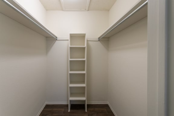 This is a photo of the primary bedroom walk-in closet in the 880 square foot 2 bedroom, 2 bath apartment at Canyon Creek Apartments in Dallas, TX