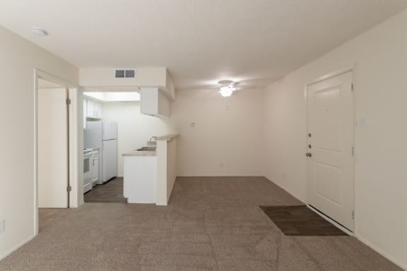 This is a photo of the kitchen and dining area from the living room in a 515 square foot 1 bedroom, 1 bath apartment at Canyon Creek Apartments in Dallas, TX