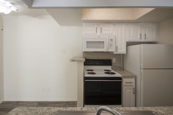 This is a photo of the kitchen of the 550 square foot 1 bedroom apartment at Canyon Creek Apartments in Dallas, TX