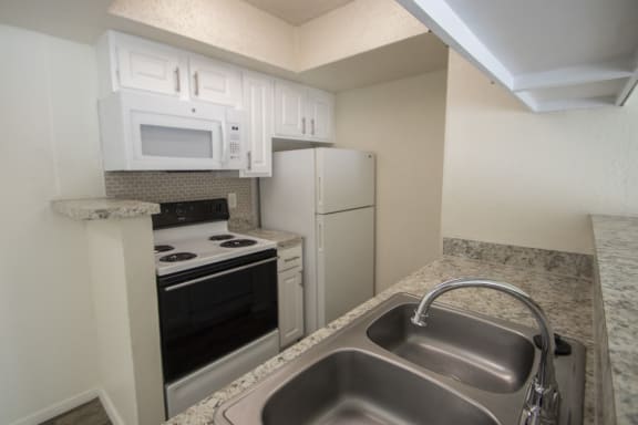 This is a photo of the kitchen of the 550 square foot 1 bedroom apartment at Canyon Creek Apartments in Dallas, TX