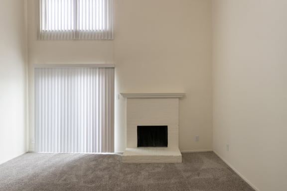 This is a photo of the living room with fireplace in a 717 square foot 1 bedroom, 1 bath apartment at Canyon Creek Apartments in Dallas, TX