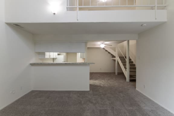 This is a photo of the kitchen and diding rooms from the living room in a 717 square foot 1 bedroom, 1 bath apartment at Canyon Creek Apartments in Dallas, TX