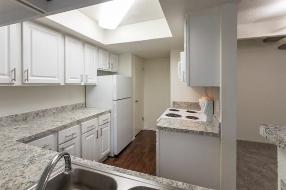 This is a photo of the kitchen in a 717 square foot 1 bedroom, 1 bath apartment at Canyon Creek Apartments in Dallas, TX