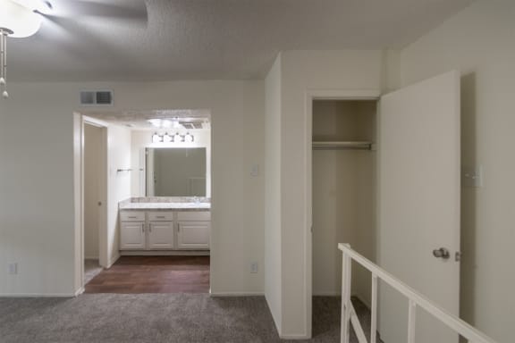 This is a photo of the loft/bedroom upstairs closet in a 717 square foot 1 bedroom, 1 bath apartment at Canyon Creek Apartments in Dallas, TX