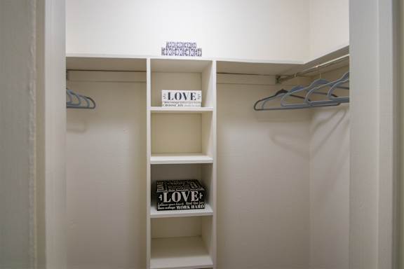 The bedroom ealk-in closet in a 515 square foot 1 bedroom, 1 bath apartment home at Canyon Creek Apartments in Dallas Midtown neighborhood of Dallas, TX.