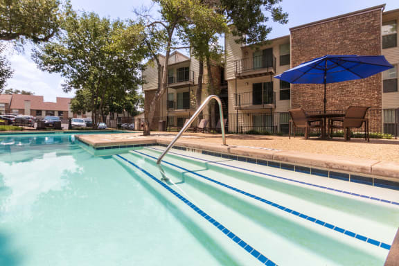 This is a photo of the pool area at Canyon Creek Apartments in Dallas, TX.