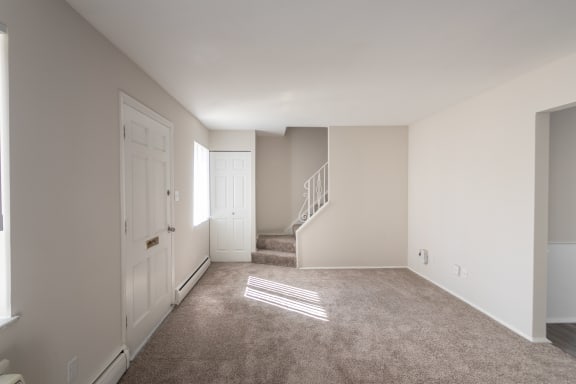This is a photo of the living room of the 1004 square foot, 2 bedroom/1 bath Townhome with stackable washer/dryer floor plan at Colonial Ridge Apartments in the Pleasant Ridge neighborhood of Cincinnati, OH.