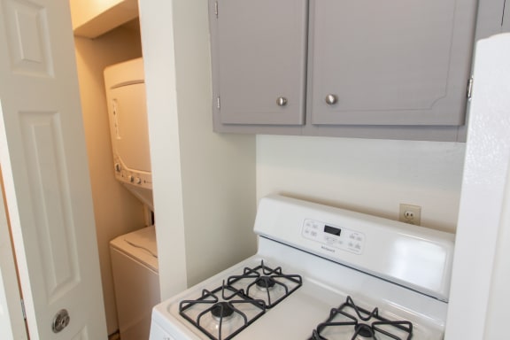 This is a photo of the stackable washer/dryer in the closet located in the kitchen  of the 1004 square foot, 2 bedroom townhome floor plan at Colonial Ridge Apartments in Cincinnati, OH.