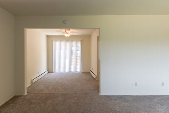 This is a photo of dining room from the living room in the 1004 square foot, 2 bedroom townhome floor plan at Colonial Ridge Apartments in Cincinnati, OH.