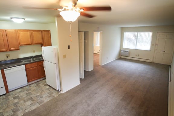 This is a photo of the kitchen and living room taken from the dining area in the 631 square foot 1 bedroom, 1 bath floor plan at Colonial Ridge Apartments in Cincinnati, OH.