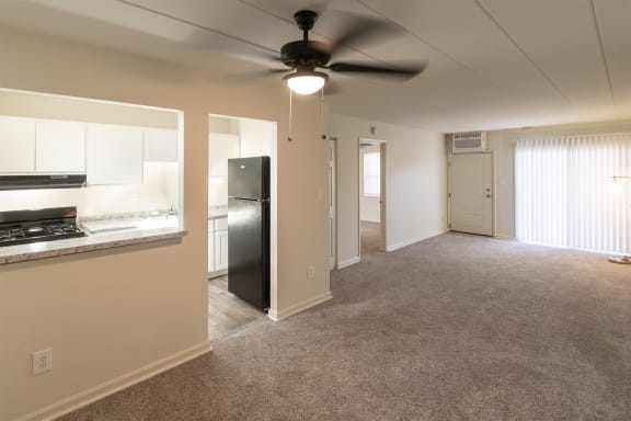 This is a photo of the dining area and living room in the 550 square foot 1 bedroom, 1 bath patio apartment at College Woods Apartments in the North College Hill neighborhood of Cincinnati, OH.