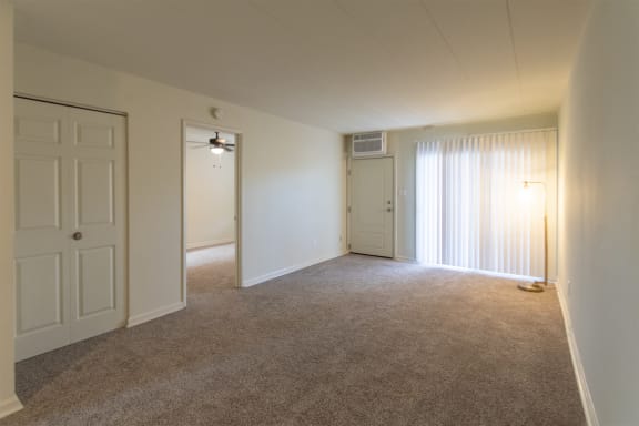 This is a photo of the living room in the 550 square foot 1 bedroom, 1 bath patio apartment at College Woods Apartments in the North College Hill neighborhood of Cincinnati, OH.