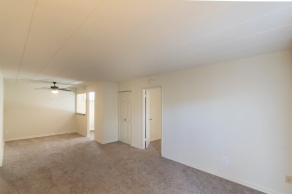 This is a photo of the living room and dining area in the 550 square foot 1 bedroom, 1 bath patio apartment at College Woods Apartments in the North College Hill neighborhood of Cincinnati, OH.