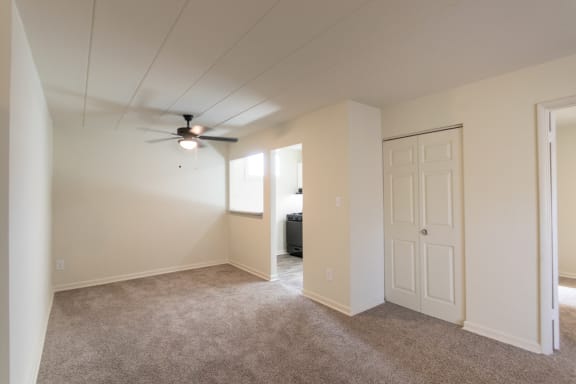 This is a photo of the living room and dining area in the 550 square foot 1 bedroom, 1 bath patio apartment at College Woods Apartments in the North College Hill neighborhood of Cincinnati, OH.