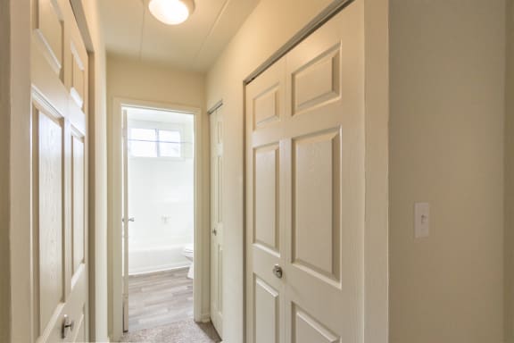 This is a photo of the hallway leading to the bathroom in the 550 square foot 1 bedroom, 1 bath patio apartment at College Woods Apartments in the North College Hill neighborhood of Cincinnati, OH.