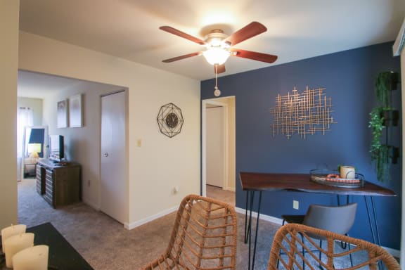 This is a photo of the dining room of the 550 square foot 1 bedroom, 1 bath, balcony floor plan model apartment at College Woods Apartments in Cincinnati, OH.