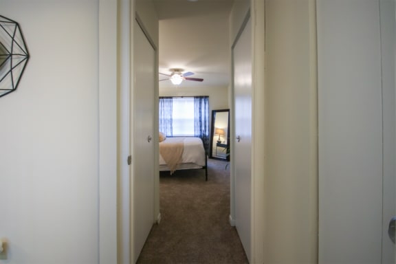 This is a photo of the bedroom hallway of the 550 square foot 1 bedroom, 1 bath, balcony floor plan model apartment at College Woods Apartments in Cincinnati, OH.